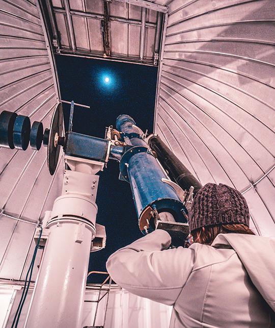 person using observatory telescope